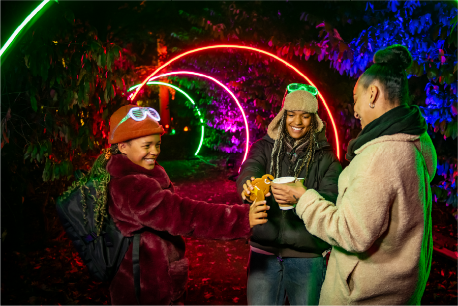 A colourful illuminated character on the winter trail